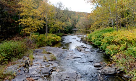 A FBI agent searches a creek bed in Henryville, Pennsylvania, during the manhunt for accused cop killer Eric Frein.