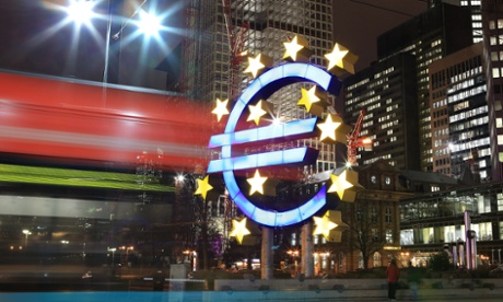 A tram passes the giant Euro symbol outside the headquarters of the European Central Bank in Frankfurt, Germany.
