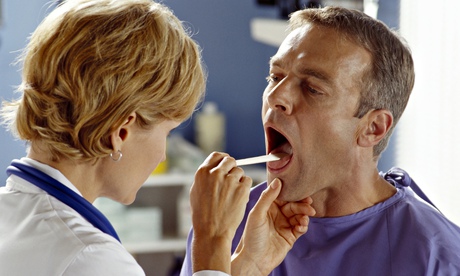 Doctor examining patient's throat