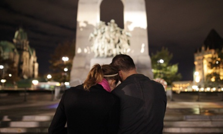 A couple pay their respects for Cpl Nathan Cirillo, who was shot standing guard at the National War Memorial in Ottawa.