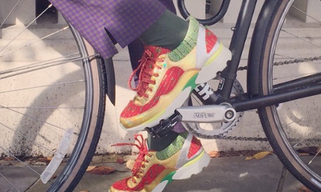 Laura Bailey Bike cycles in Chanel trainers and Prada slacks