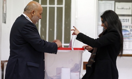 A woman casts her ballots in the Tunisian consulate in Paris