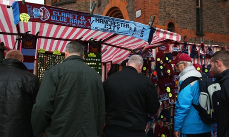 Fans peruse the items on offer outside Upton Park. £9, though. For a half-and-half!
