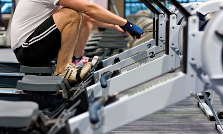 Man working out on rowing machine in health club