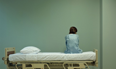 Female patient sitting on hospital bed