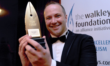 Steve Pennells holds gold Walkley