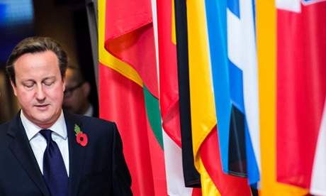 David Cameron walking past EU member state flags as he left the summit at the EU Council building in Brussels on Friday