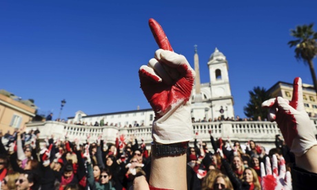 Women hold up their hands at a rally to end violence towards women in Italy.