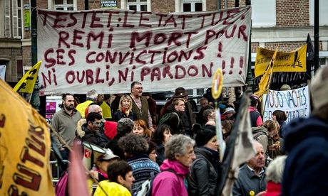 Members of a French farm labour union stand beneath a banner in memory of Remi Fraisse