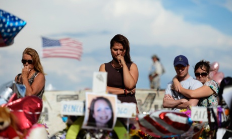 Cynthia Davis gets emotional as she visits the roadside memorial set up for victims of the Colorado theater shooting massacre in Aurora, Colorado.