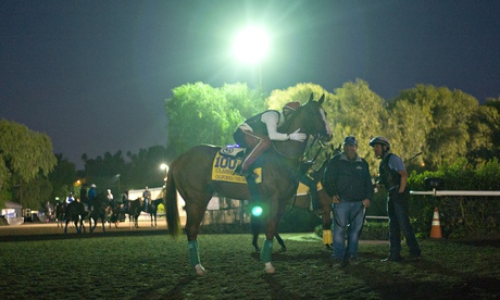 Willie Delgado pats California Chrome as they wait for a workout at the Breeders' Cup