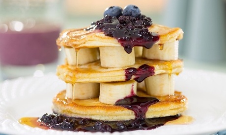 A stack of fruit and American pancakes