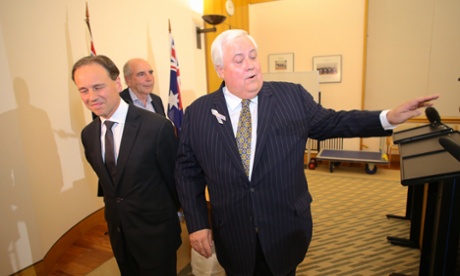 Environment minister Greg Hunt, PUP leader Clive Palmer and Bernie Fraser on their way to a press conference.