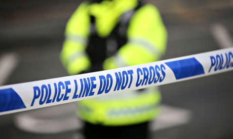 Police tape and officer 