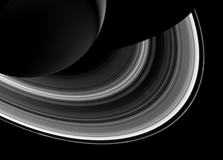 Among the interplay of Saturn's shadow and rings, Mimas, which appears in the lower-right corner of the image, orbits Saturn as a set of the ever-intriguing spokes appear in the B ring (just to the right of center).