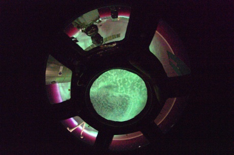 Fisheye aurora  Breathtaking from ISS. Flying through a red Aurora, with a green one right beneath us.