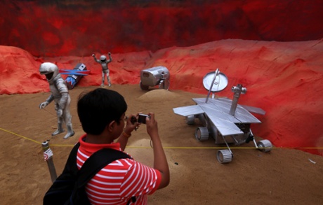 An Indian boy takes picture of a pandal art installation entitled 'Mars Mission' with a replica of the Mars Pathfinder and astronauts figures during the Durga Puja festival in Calcutta, India, 30 September 2014. The Indian Space Research Organisation (ISRO) successfully send an orbiter spacecraft to Mars in September. The Hindu festival of Durga Puja celebrates the killing of a demon king by the goddess. The event runs from 30 September to 04 October.