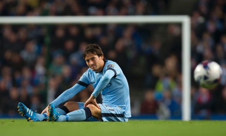 Manchester City's David Silva sits on the pitch after being injured during the English League Cup soccer match between Manchester City and Newcastle at the Etihad Stadium, Manchester, England, Wednesday Oct. 29, 2014. (AP Photo/Jon Super)