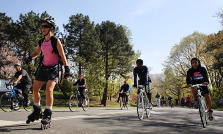 Cyclists, runners and skaters exercise around Central Park.