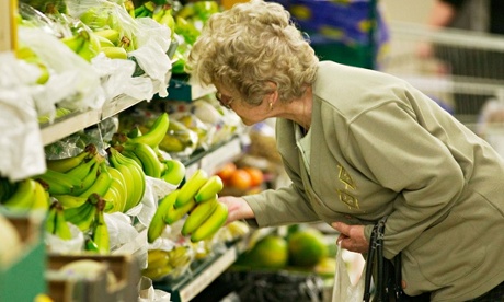 Woman choosing bananas in supermarket