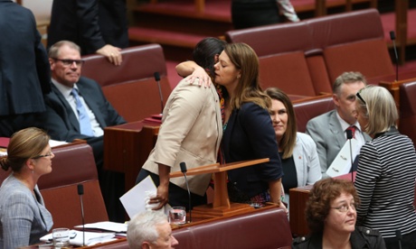 Senator Nova Peris is comforted by Sarah Hanson Young.