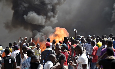 Smoke rises outside Burkina Faso's national assembley