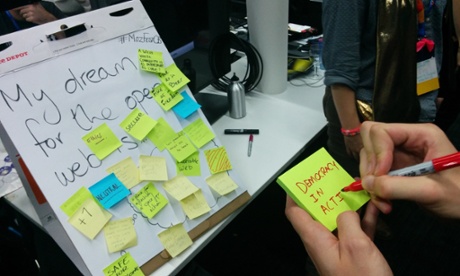 Guardian developer Will Franklin filling in a sign for 