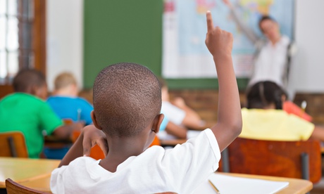Pupil raising hand in classroom