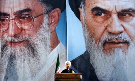 President Hassan Rouhani delivers a speech under portraits of Ayatollah Ali Khamenei (left) and Iran's founder of the Islamic Republic, Ayatollah Ruhollah Khomeini.