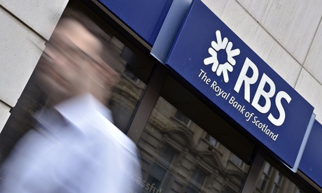 A man walks past a branch of the Royal Bank of Scotland