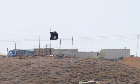 An Islamic State (ISIS) black flag flies near the Syrian town of Kobani, October  27, 2014  as seen from the Turkish-Syrian border near the southeastern town of Suruc in Sanliurfa province, Turkey.