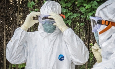 Health workers wear protective gears before entering the house of a person suspected to have died of Ebola virus in Port loko Community situated on the outskirts of Freetown, Sierra Leone, Tuesday, Oct. 21, 2014.