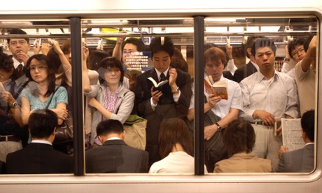 Commuters on the subway at Shinjuku Station Tokyo 