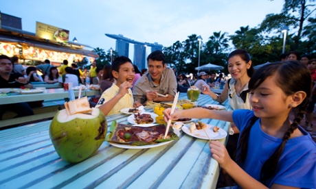 Family enjoying street food outdoors, Singapore