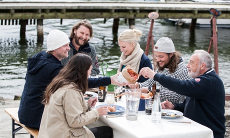 a family enjoys seafood in Swedish harbour