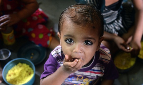 Indian children eat their free supplementary snack at the Apnalaya nutrition centre on the outskirts of Mumbai