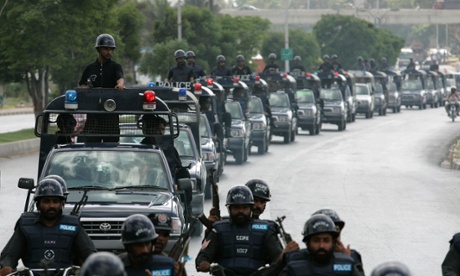 Pakistani police officers patrol the streets of Karachi.
