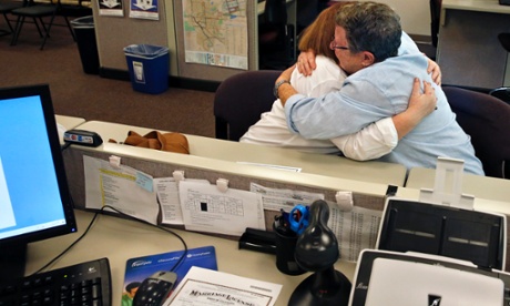 Same-sex couple Jennifer Knight, left, and Felice Cohen hug after receiving their marriage license, visible at bottom left, inside the offices of the Boulder County Clerk and Recorder, in Colorado. same-sex marriage