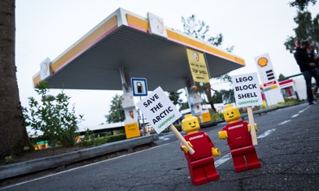Greenpeace places 10 LEGO mini activist figures at a Shell gas station in Legoland in Billund, Denmark with banners reading 