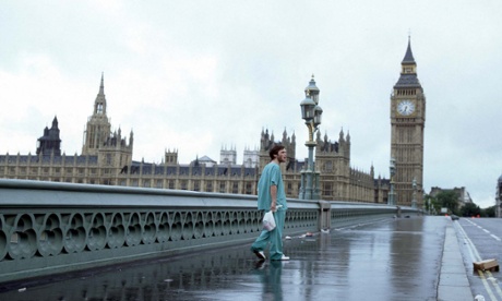 Jim (Cillian Murphy) walks distractedly across Westminster bridge with Parliament in the background,  as he survives a virus that wipes out most of the Earth's population in a still from the film 28 Days Later.