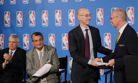 ESPN President John Skipper shakes hands with NBA Commissioner Adam Silver. (AP Photo/Mark Lennihan)