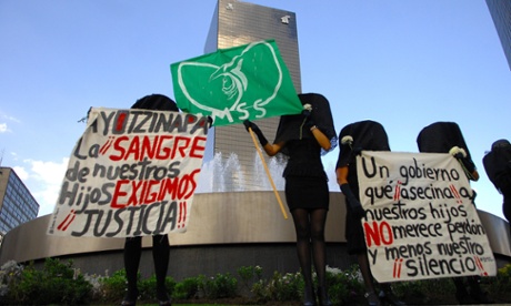 A protestor holds a placard reading in English 