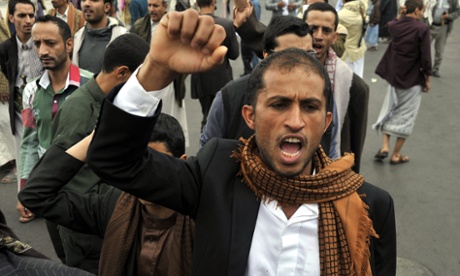 A Yemeni shouts anti-government slogans at the site of the suicide bombing.