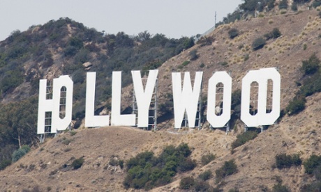 Endeavour on top flies past the Hollywood sign