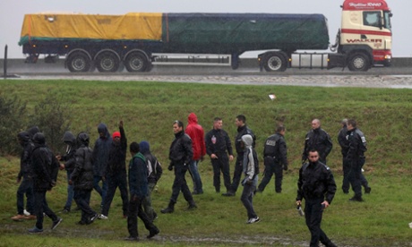 The road to El Dorado? French police stop migrants attempting to board a lorry bound for Britain.