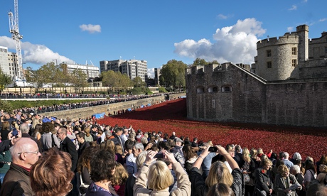 Visitors view the poppy artwork at the Tower of LOndon