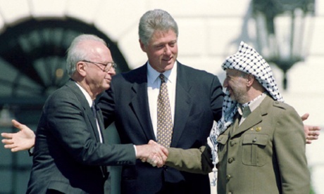 Palestinian President Yasser Arafat is seen with U.S. President Bill Clinton and Israeli Prime Minister Yitzhak Rabin after the signing of the Israeli-PLO peace accord at the White House, September 13, 1993