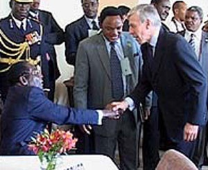Jack Straw shaking hands with Robert Mugabe - BBC Newsnight