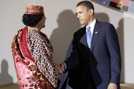 US President Barack Obama (R) and Libyan Leader Moamer Kadhafi shake hands during the Group of Eight (G8) summit in L'Aquila, central Italy, on July 9, 2009