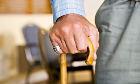 An elderly man holding a walking stick